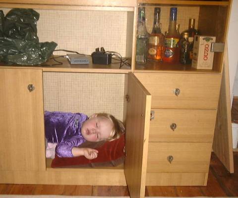 Photo of Marianne sleeping in cupboard